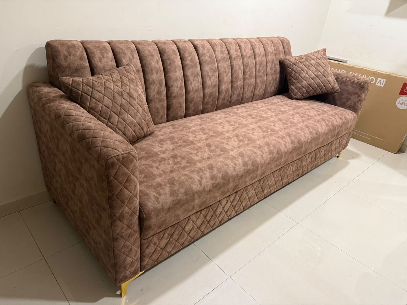 Mauve sofa with quilted sides