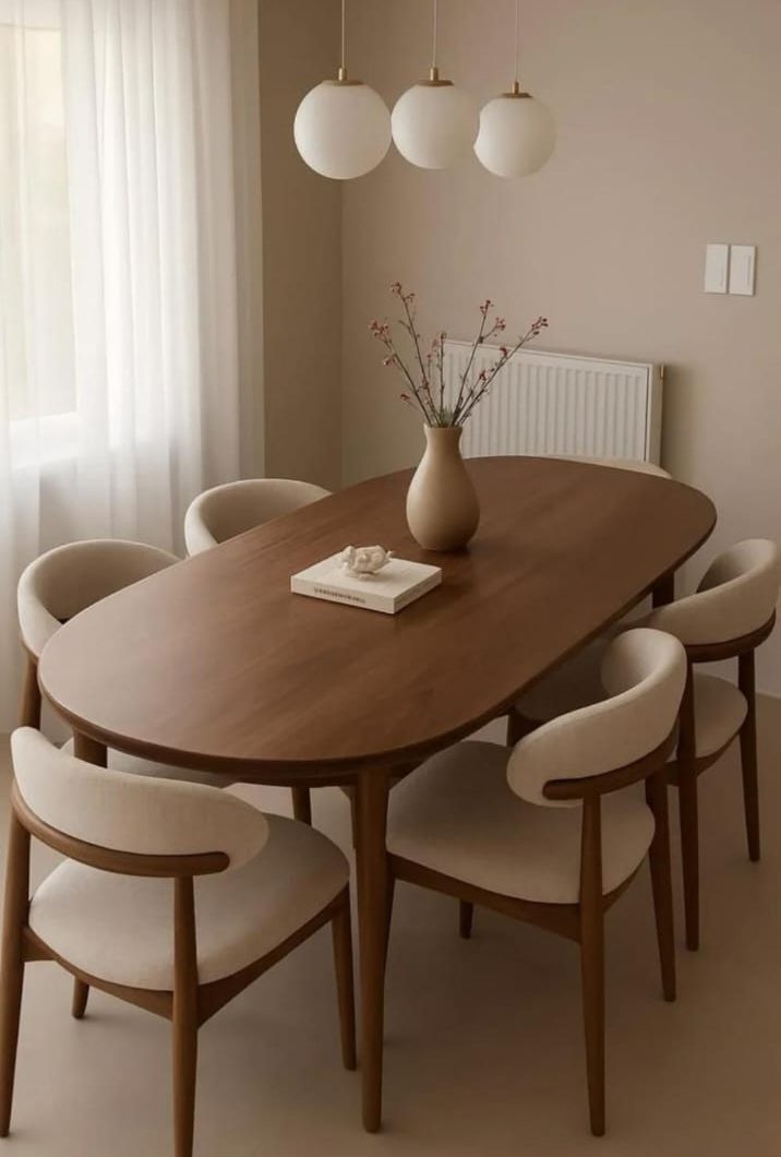 Oval wooden dining table with six upholstered chairs