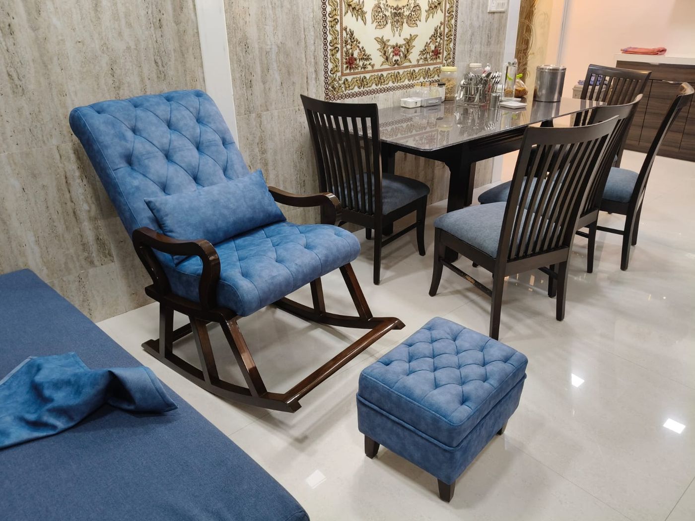 Blue button-tufted rocking chair with matching ottoman