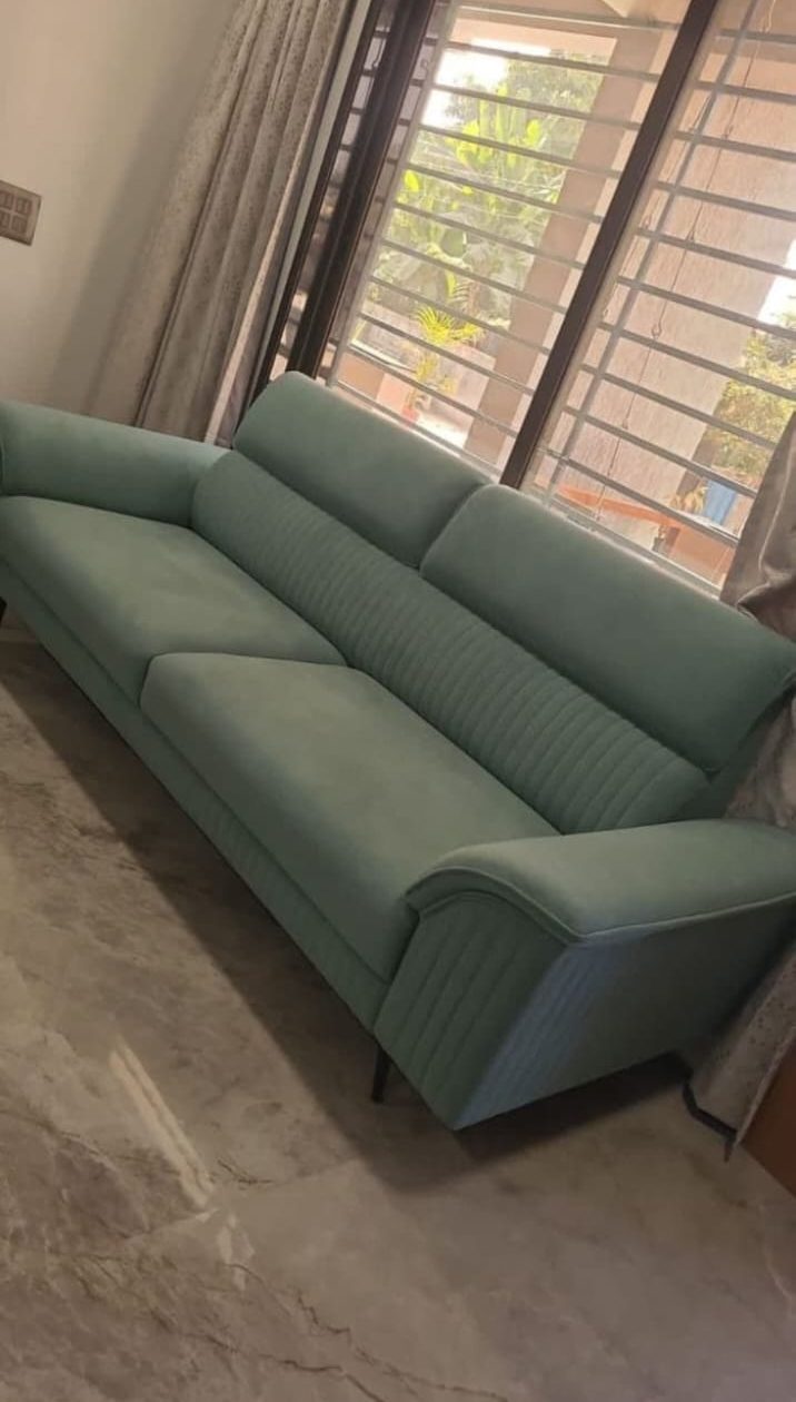 Teal sofa with adjustable headrests