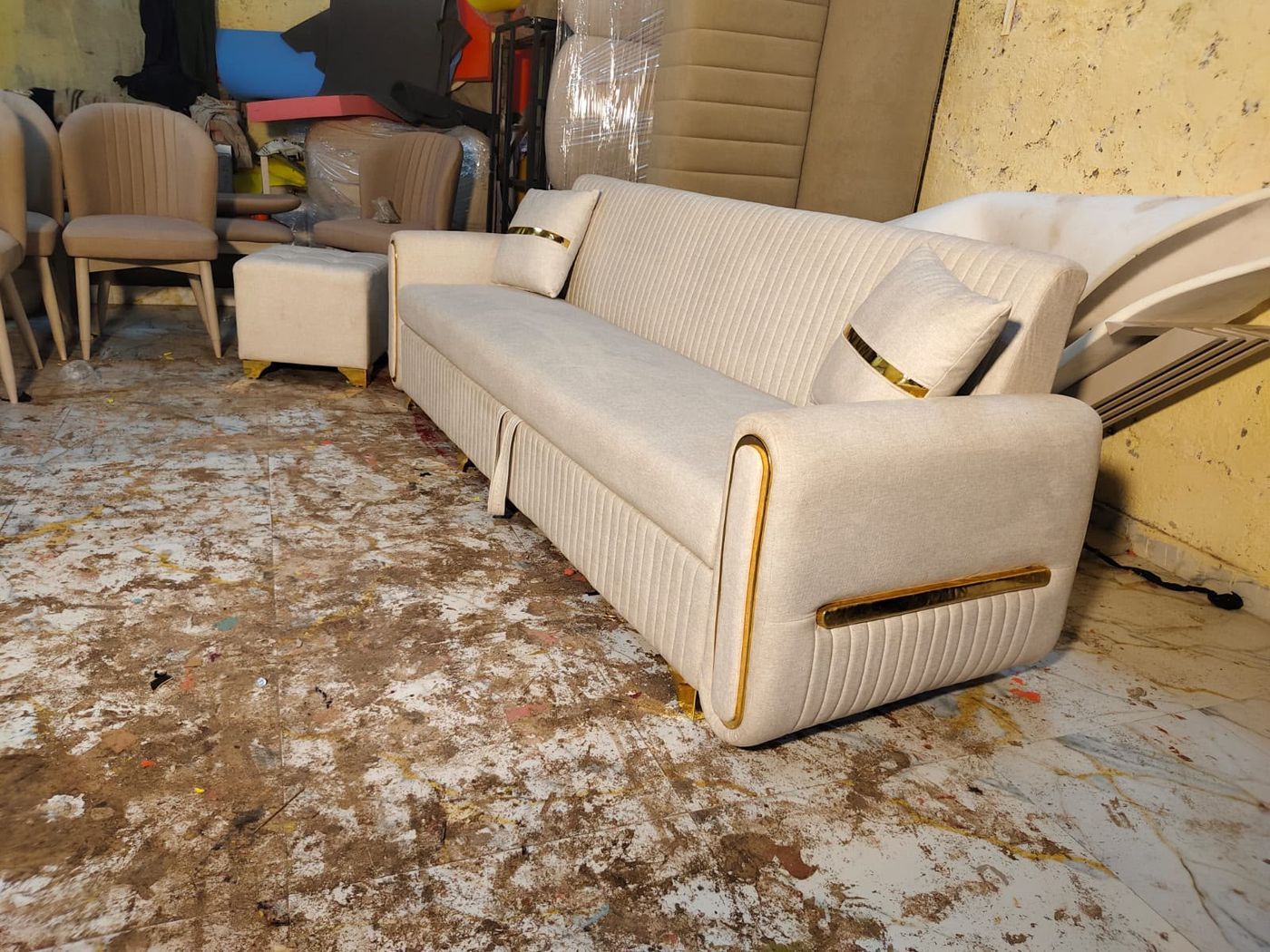 Ivory sofa with gold trim on the arms